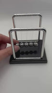 Newtons cradle video to show the Newton’s Cradle in motion  – desktop fidget and sensory stress relief toy | The Divergent Den